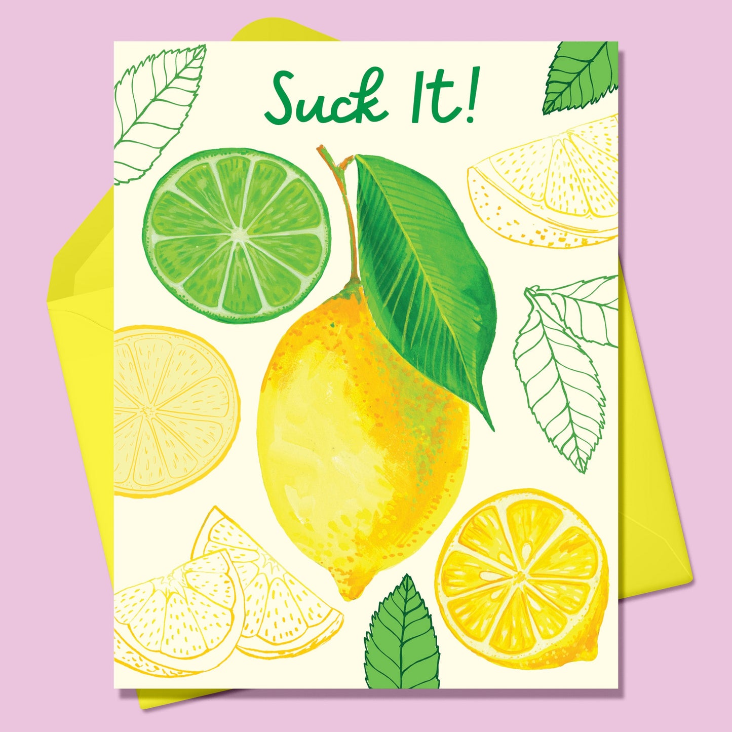 Paper Greeting card with the image of various lemons- a whole lemon in the center surrounded by cut lemons and green leaves and one cut lime on a cream background. Text says Suck It! With a yellow envelope. On a lavender background.