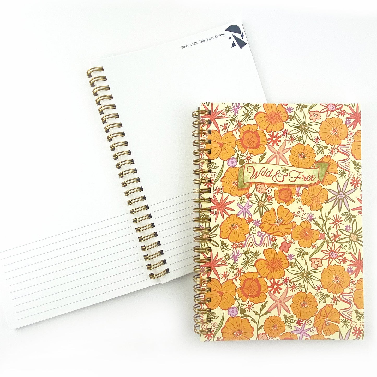 Spiral Bound Notebook with hand drawn colorful poppies and wildflowers in tones of orange , red, lavender and gold on a cream background. In the center is the handlettered phrase Wild and Free on a cream colored banner.
