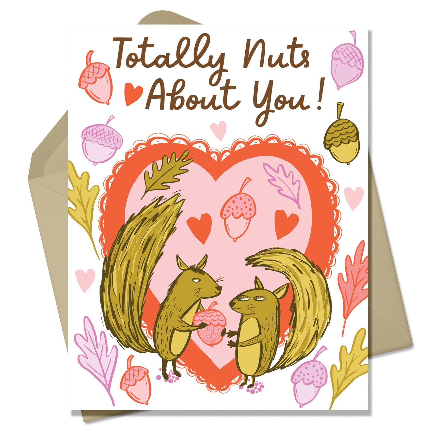 Valentine and love card featuring a squirrel giving another squirrel friend a  nut. In the background is a lacy heart shape and pink and purple nuts and leaves. Little hearts float around the card too. There is a kraft colored envelope in the background. 