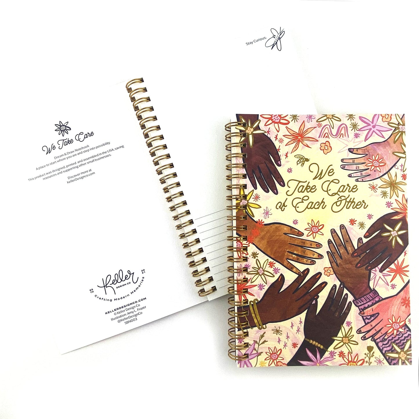 Spiral Bound notebook with hand drawn artwork of multi racial hands and flowers. In the center text says We Take Care of Each Other.